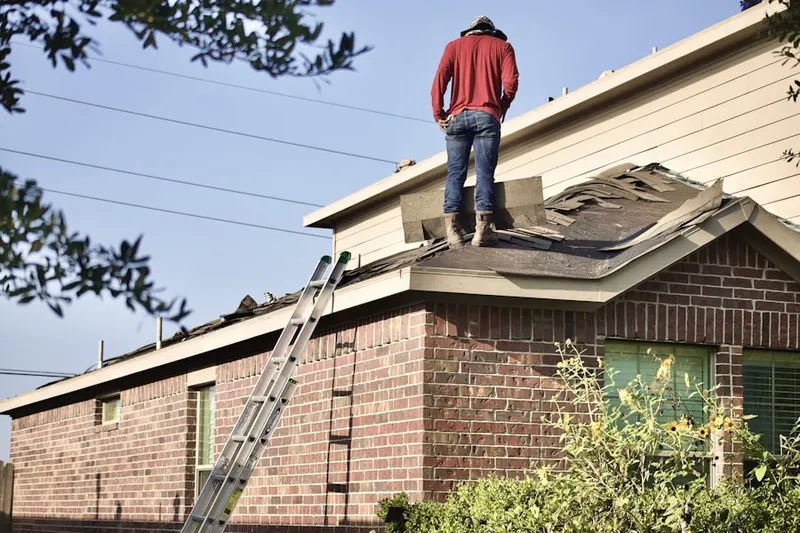 Professional roofer working on a residential roof in Schuyler